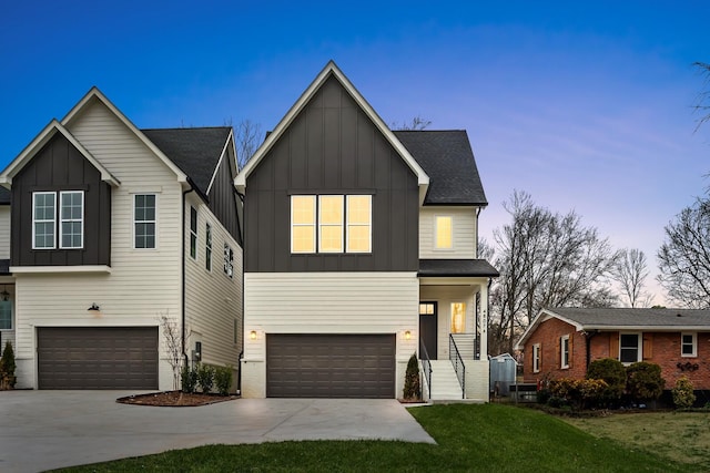 view of front of house with a garage and a yard