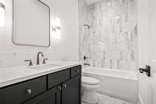 full bathroom featuring vanity, tiled shower / bath combo, and toilet