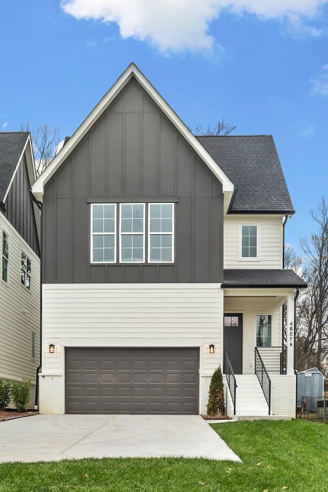 view of front of house featuring a garage, a front yard, and a porch