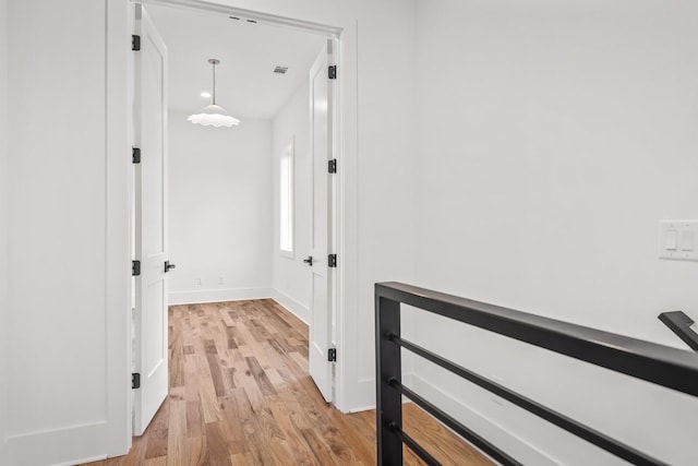 hall with light hardwood / wood-style floors