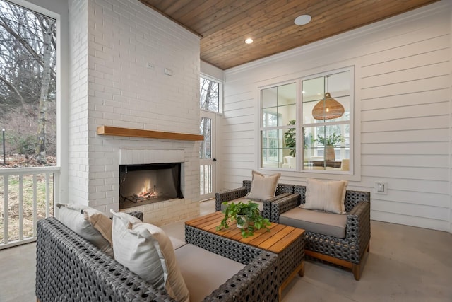 sunroom / solarium featuring wooden ceiling and a fireplace