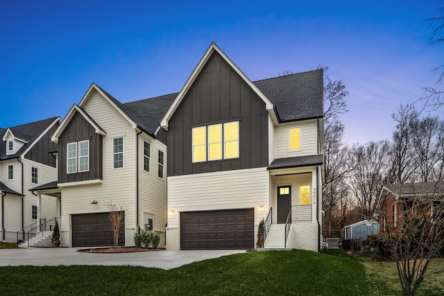 view of front of house with a garage and a yard