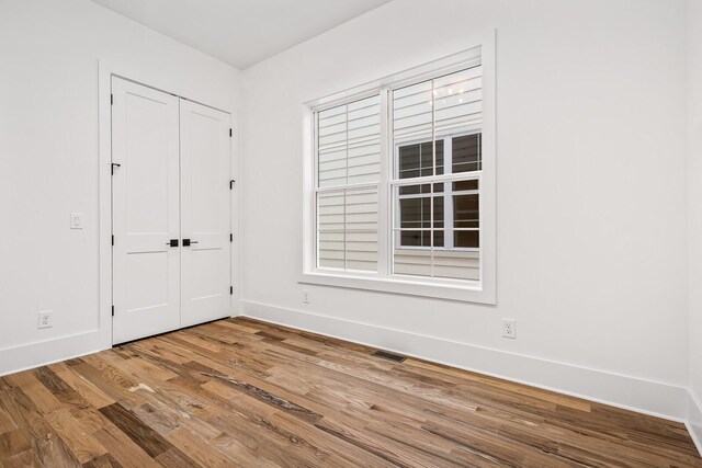 empty room featuring hardwood / wood-style flooring