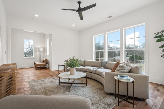 living room featuring ceiling fan and light wood-type flooring