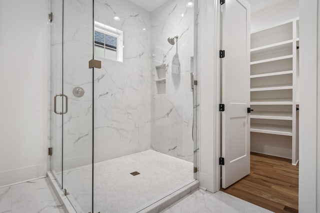 bathroom featuring a shower with shower door