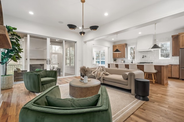 living room featuring sink and light wood-type flooring