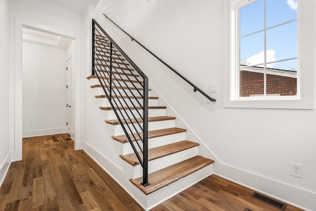 stairway with hardwood / wood-style floors