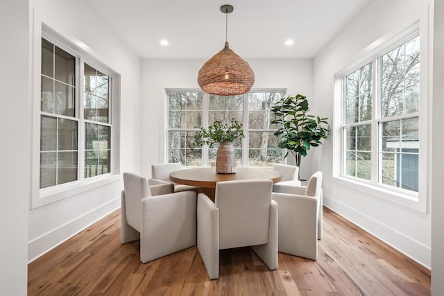 dining space with wood-type flooring