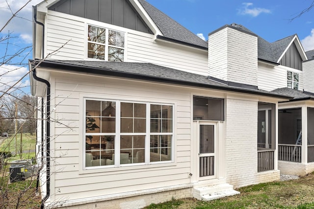 back of property featuring a sunroom and cooling unit