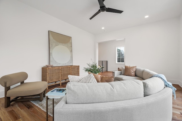 living room featuring wood-type flooring and ceiling fan