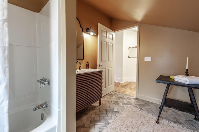 bathroom featuring vanity, parquet floors, and shower / bathtub combination