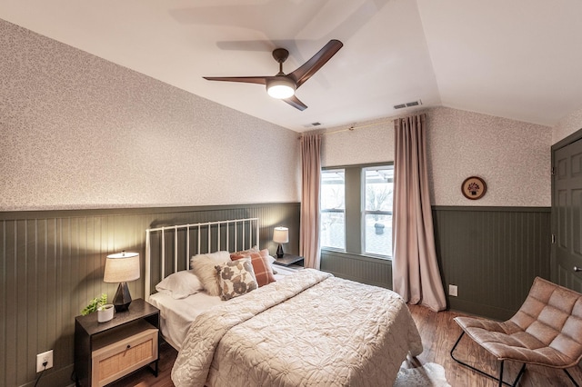 bedroom featuring ceiling fan, wood-type flooring, and vaulted ceiling