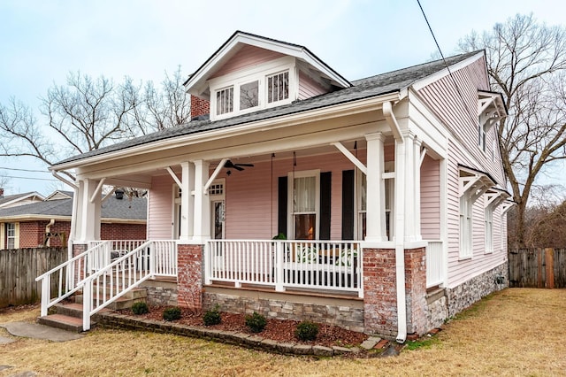 view of front of house with a front lawn, ceiling fan, and covered porch