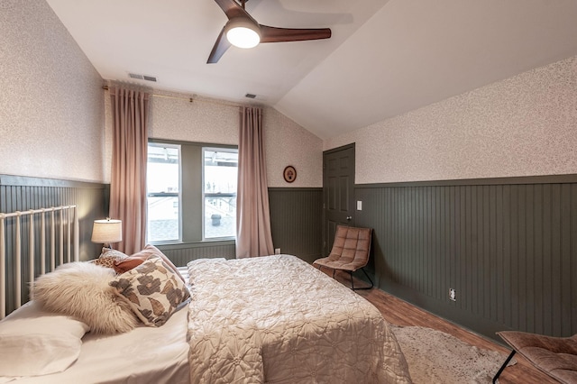 bedroom with hardwood / wood-style floors, vaulted ceiling, and ceiling fan