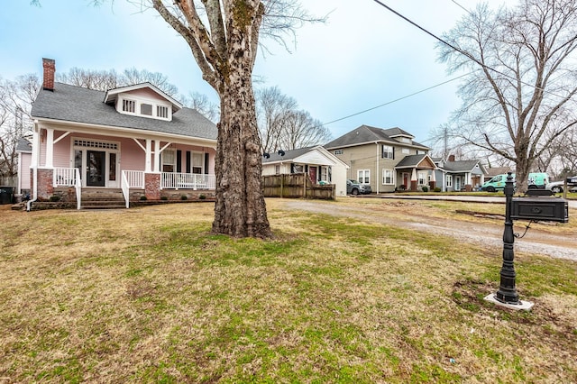 exterior space featuring a front yard and covered porch