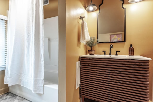 bathroom with vanity and shower / bath combo