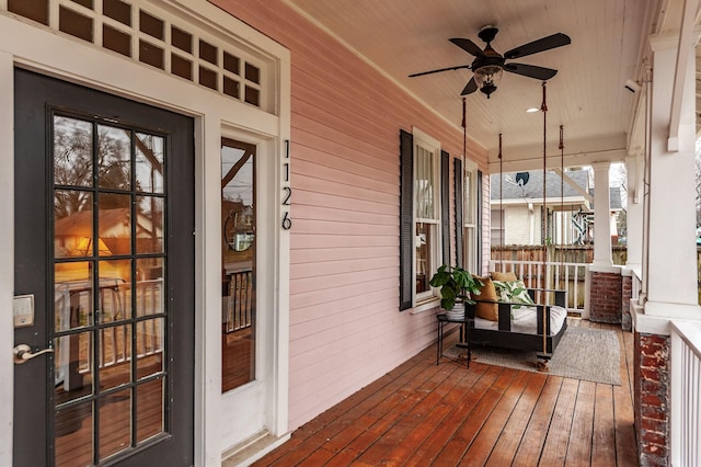 deck featuring covered porch and ceiling fan