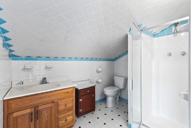 bathroom with vaulted ceiling, tile walls, vanity, walk in shower, and toilet