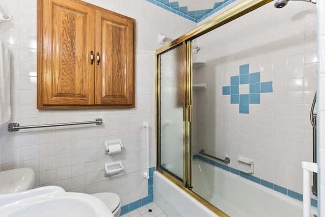 full bathroom with toilet, sink, shower / bath combination with glass door, tile walls, and tile patterned flooring