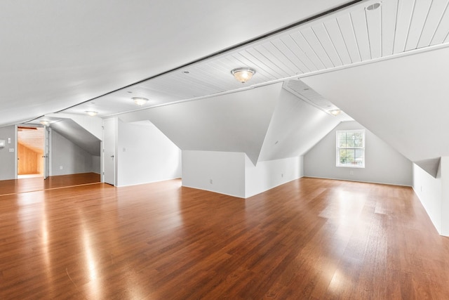 bonus room featuring wood-type flooring and vaulted ceiling