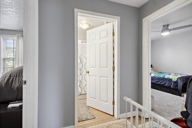 interior space featuring a textured ceiling and light hardwood / wood-style flooring