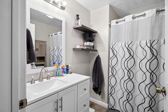 bathroom featuring vanity and a textured ceiling