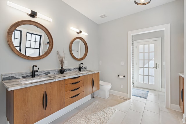 bathroom with vanity, toilet, and tile patterned flooring