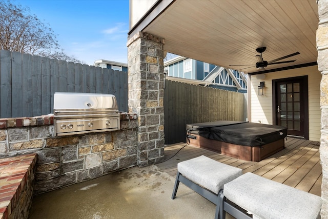 view of patio / terrace with ceiling fan, grilling area, a covered hot tub, and an outdoor kitchen