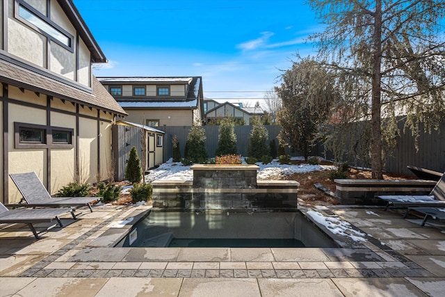 snow covered pool with a patio