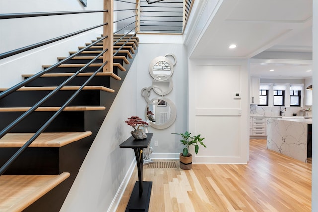 staircase with hardwood / wood-style flooring