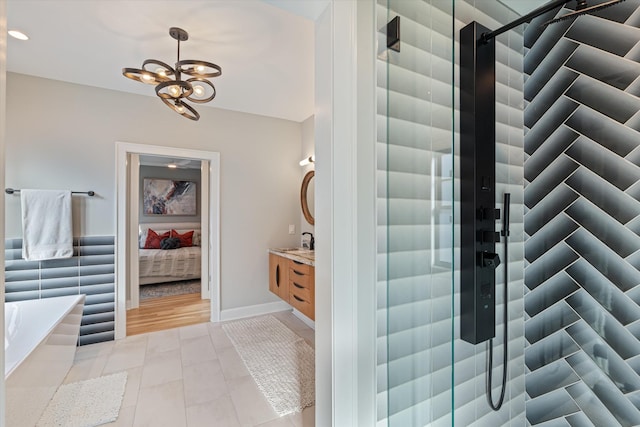 bathroom featuring vanity, a notable chandelier, and tile patterned floors