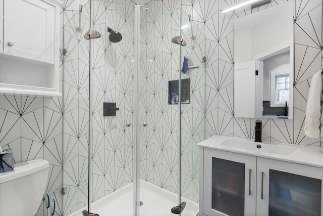 bathroom with vanity, tile walls, an enclosed shower, and toilet