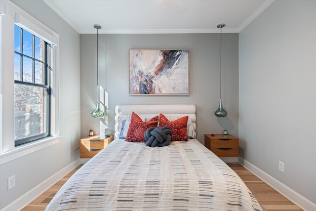 bedroom with crown molding and light hardwood / wood-style floors