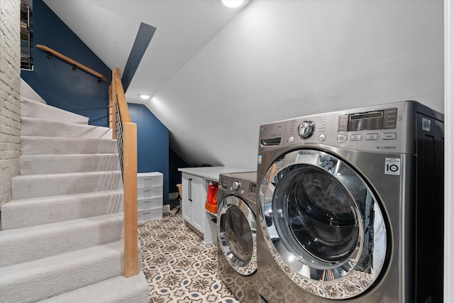 laundry area with independent washer and dryer and light colored carpet