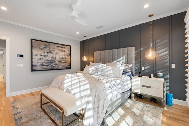 bedroom with crown molding, light hardwood / wood-style flooring, and ceiling fan