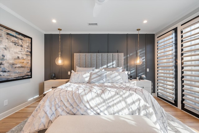 bedroom with crown molding and light hardwood / wood-style flooring