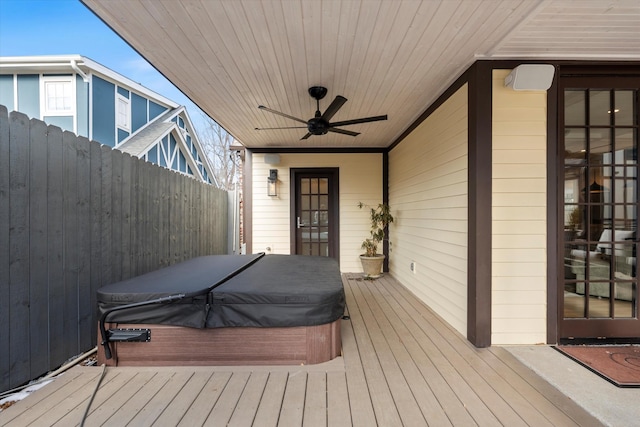 deck featuring ceiling fan and a covered hot tub