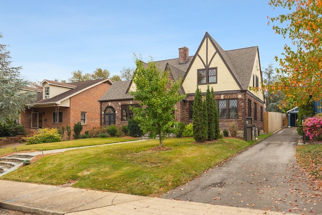 tudor home with a front yard