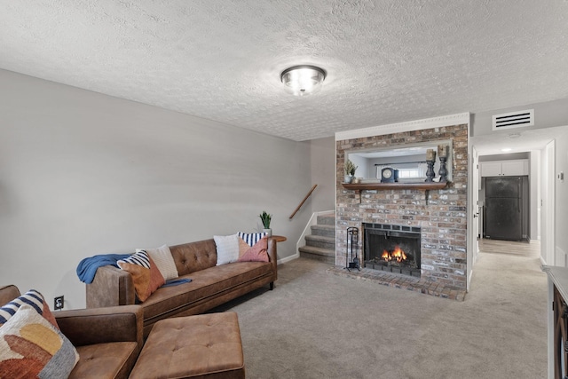 carpeted living room featuring a fireplace and a textured ceiling