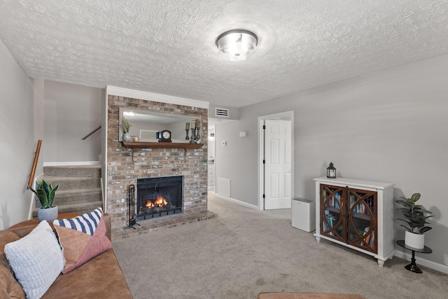 carpeted living room with a brick fireplace and a textured ceiling