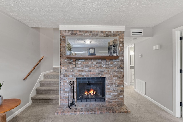 unfurnished living room featuring a fireplace, a textured ceiling, and carpet