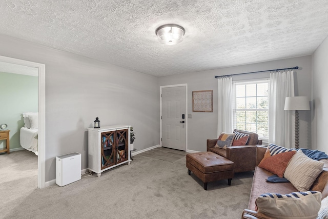 carpeted living room featuring a textured ceiling