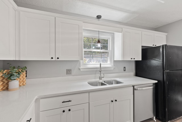 kitchen featuring sink, decorative light fixtures, a textured ceiling, dishwasher, and white cabinets