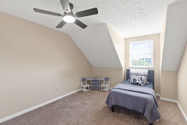 bedroom with vaulted ceiling, carpet, ceiling fan, and a textured ceiling