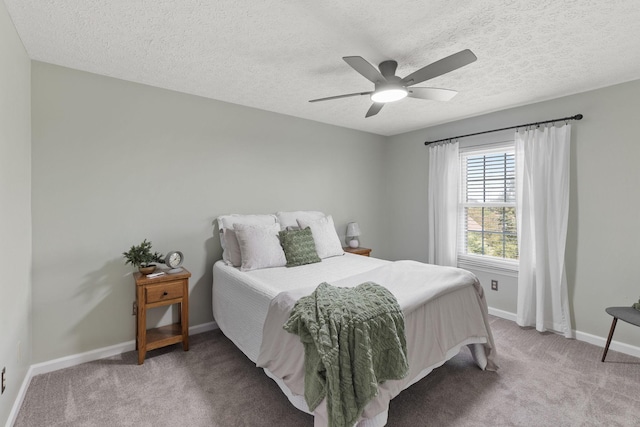 carpeted bedroom with a textured ceiling and ceiling fan