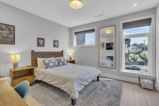 bedroom featuring multiple windows and wood-type flooring