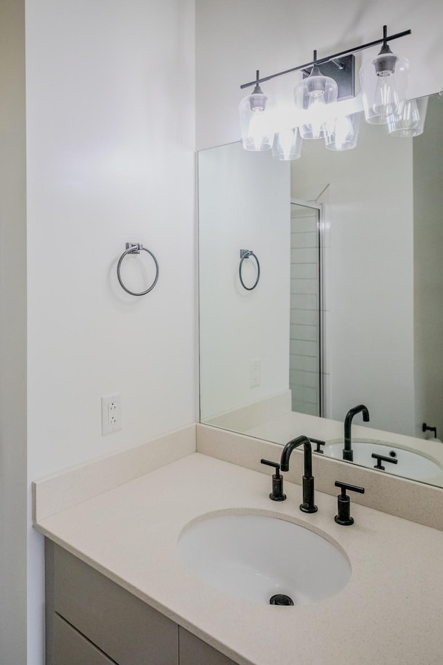 bathroom with vanity and a shower with shower door