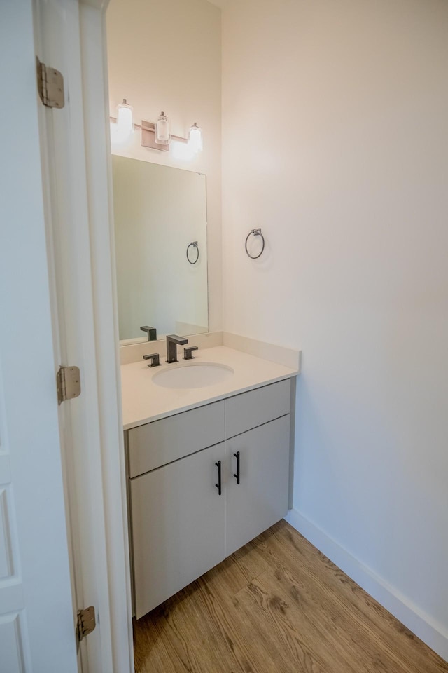 bathroom with vanity and hardwood / wood-style flooring