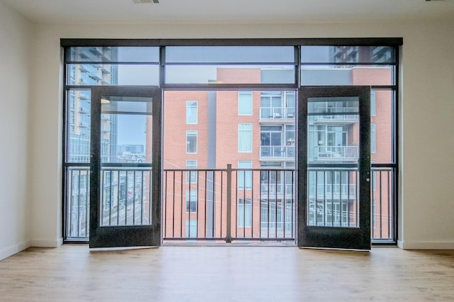 doorway to outside with plenty of natural light and hardwood / wood-style floors