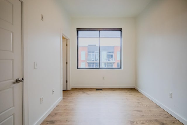 spare room with light hardwood / wood-style flooring